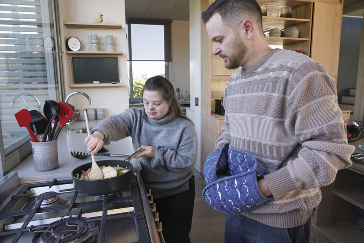Man and woman with Down Syndrome preparing dinner in kitchen London's Supported Housing System Is Under Strain: A New Report Tells Us Why